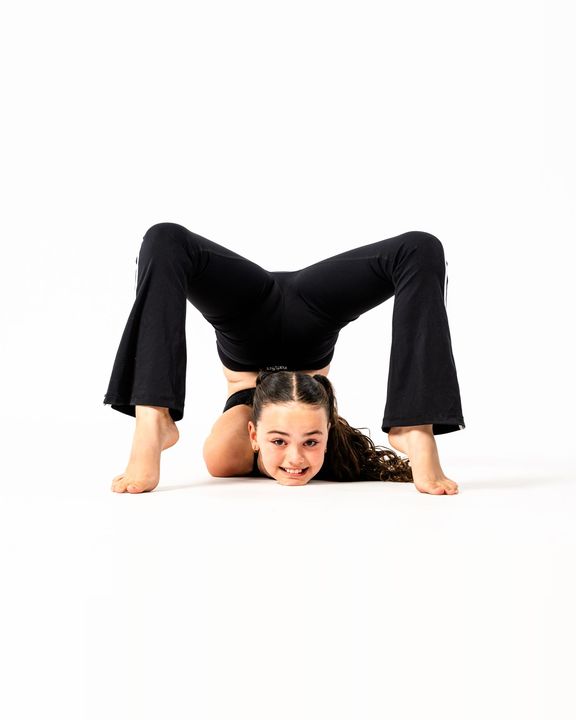 Acro dancer smiling through a backbend