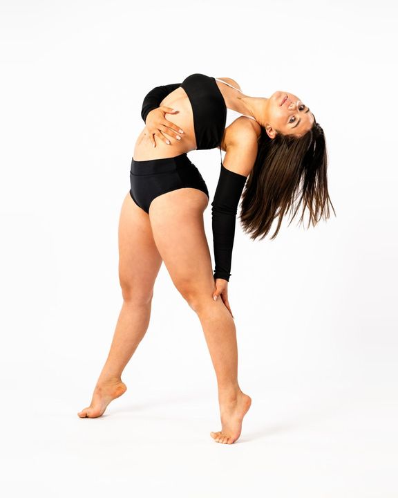 Contemporary dancer arching sideways in black