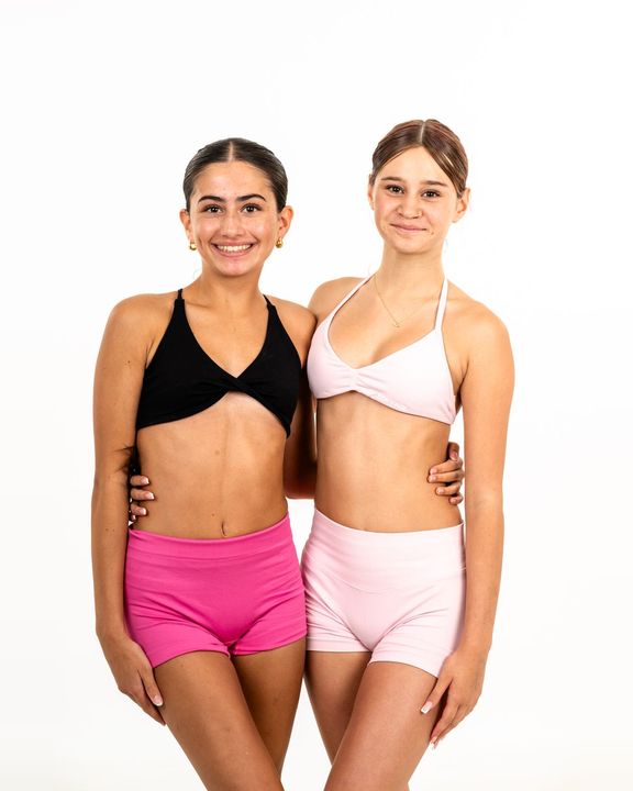 Two TDC dancers arm in arm