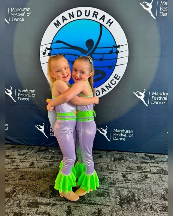 Two young TDC dancers hugging at the Mandurah Festival of Dance