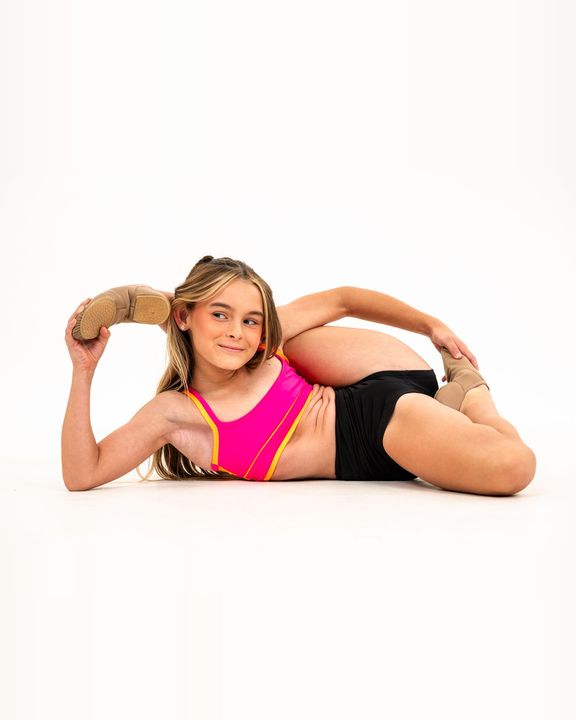 Smiling dancer in a floor stretch