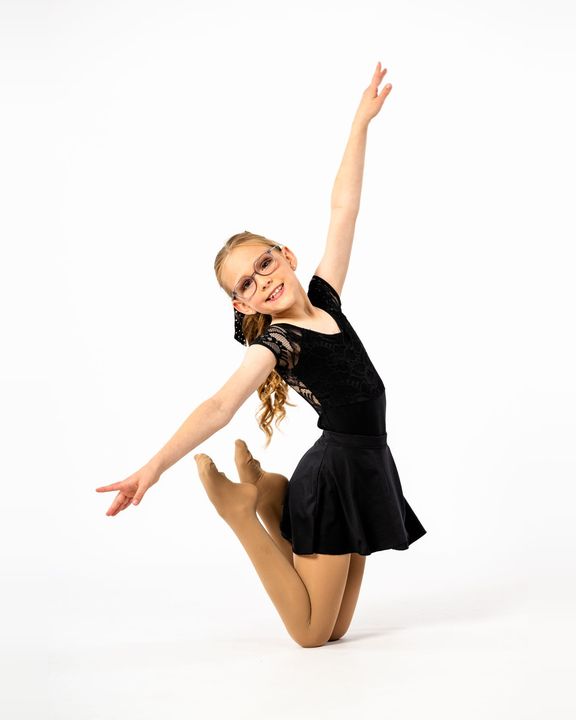 Young dancer posing with arms raised