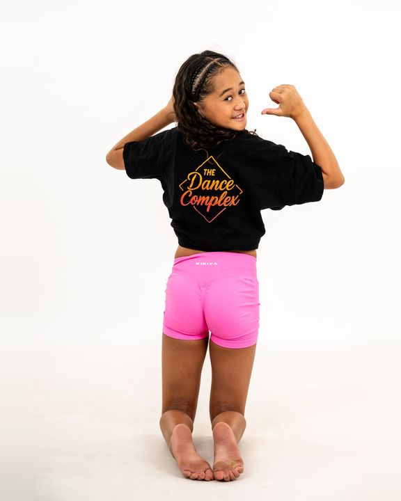 Young dancer flexing in a TDC shirt